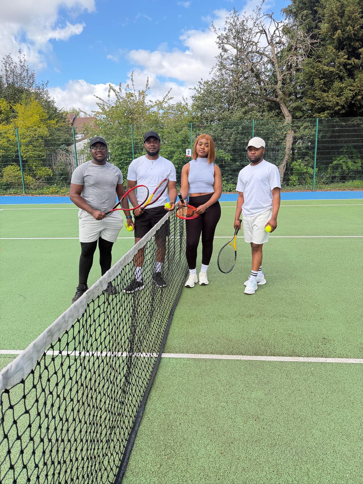 CAMUK members on a tennis court with rackets